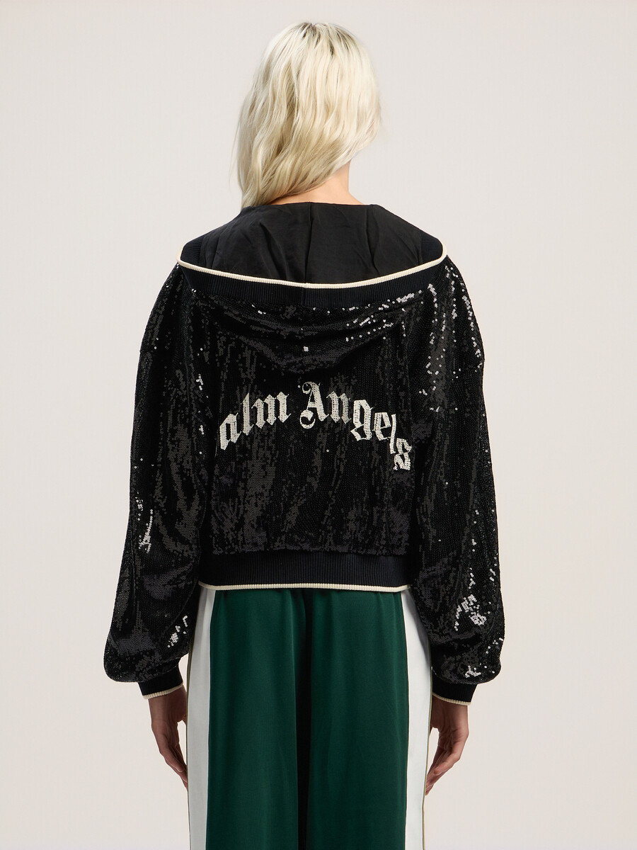 giacca corta con paillettes e logo curvo
